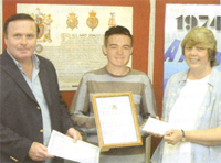 Nigel and Sue present an award to a young genealogist